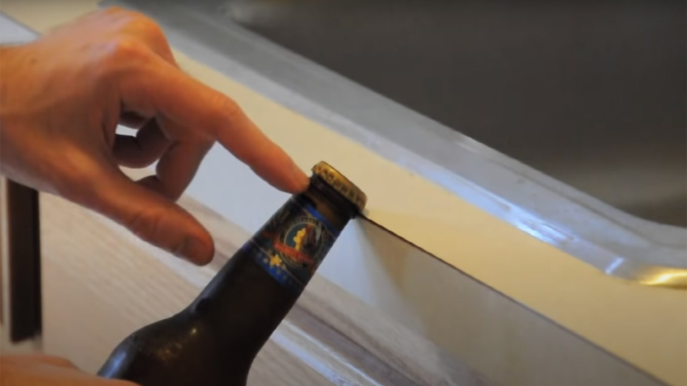 open a bottle using a table edge